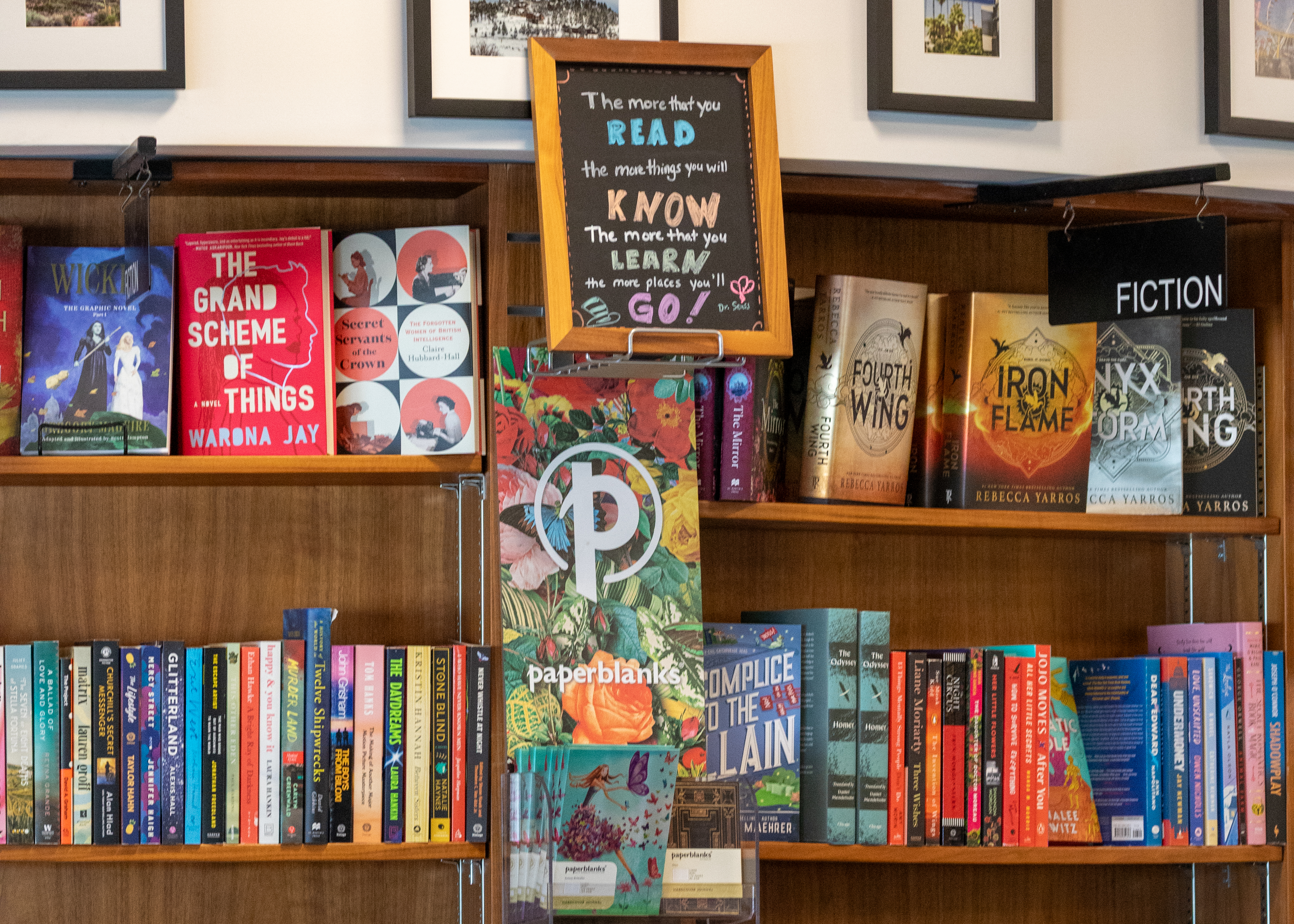 A close shot of books for sale at a Hudson store inside ONT, with a sign that quotes Dr. Seuss.