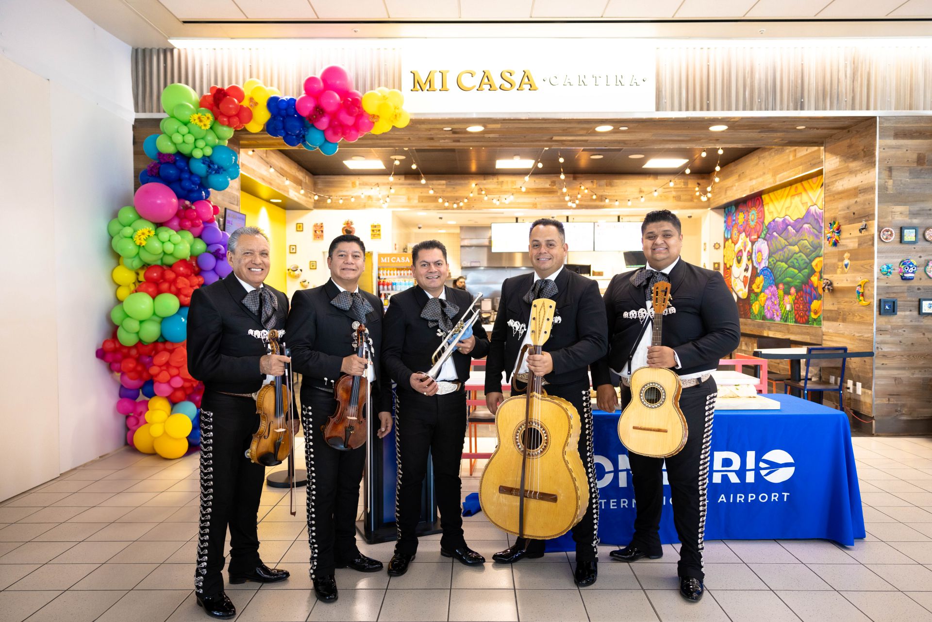 Mariachi players stand in front of Mi Casa Cantina restaurant.