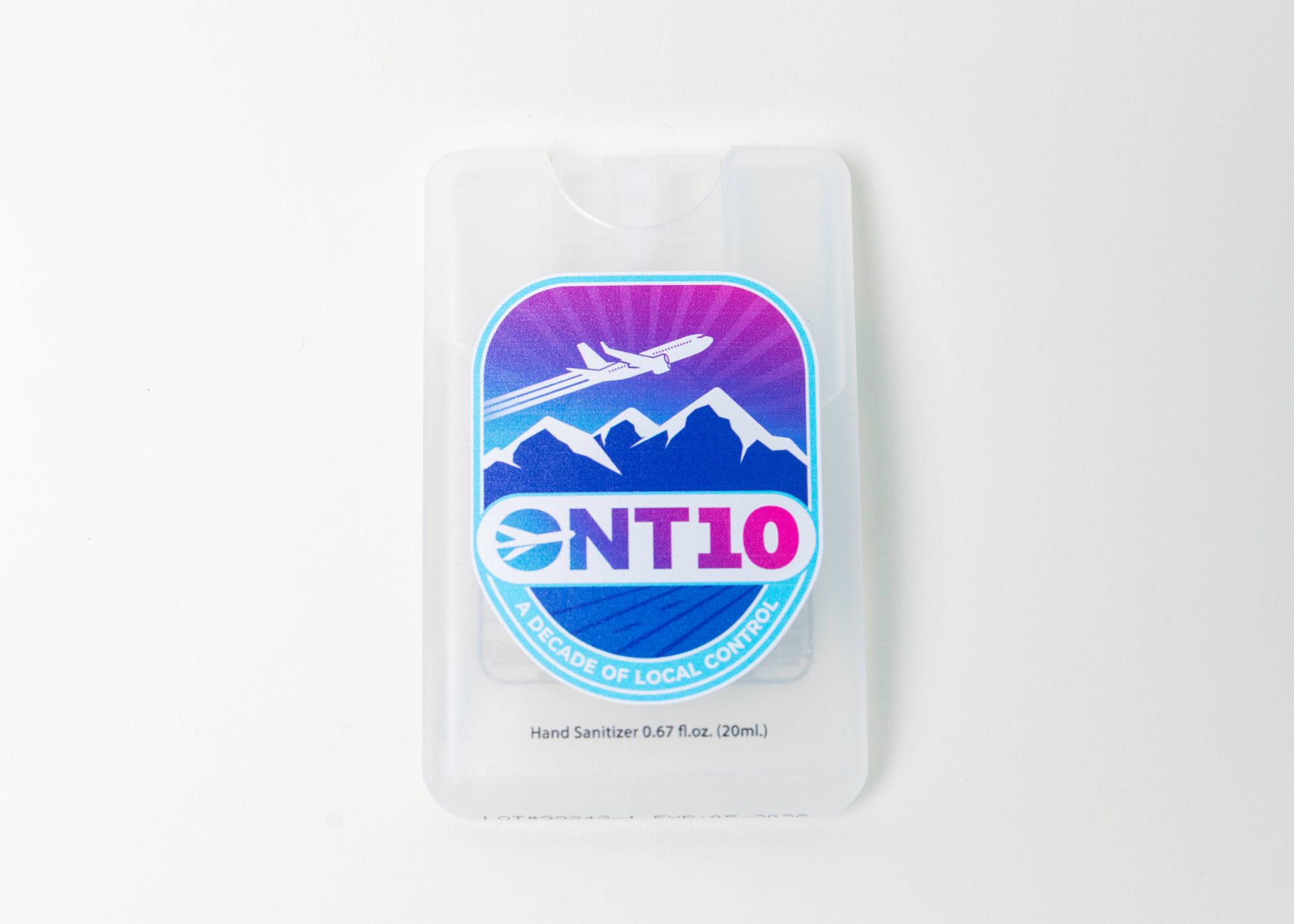 A close-up shot of a thin plastic container of hand sanitizer with the ONT10 Decade of Local Control logo on it.