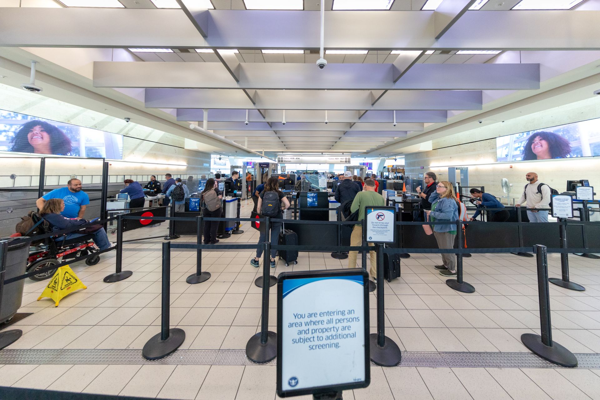 A view of the TSA screening area at ONT including a sign about a restricted area ahead.