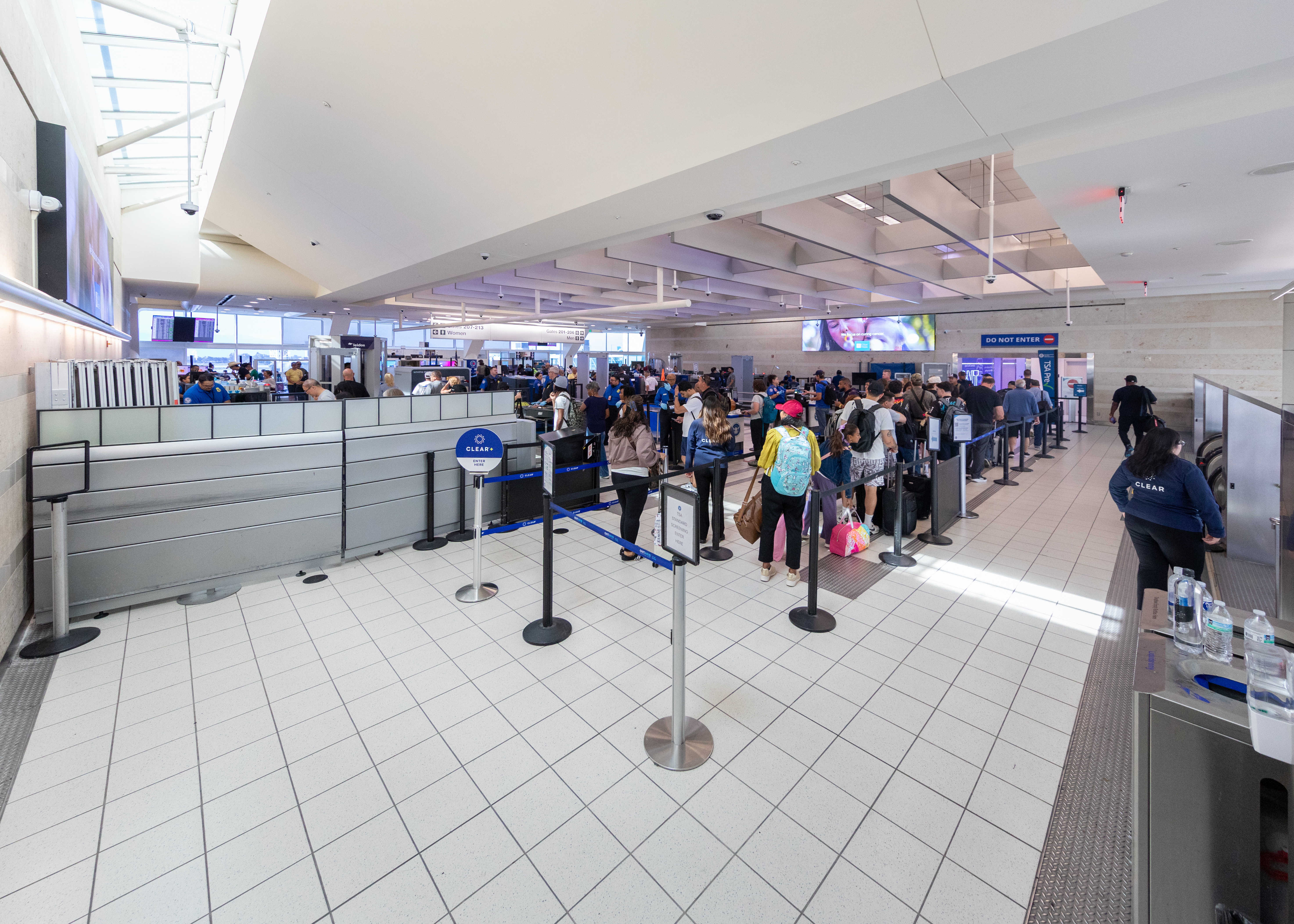 Travelers in a queue waiting to enter the T S A checkpoint. 