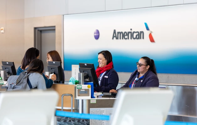 American Airlines customer service counter with staff assisting passengers