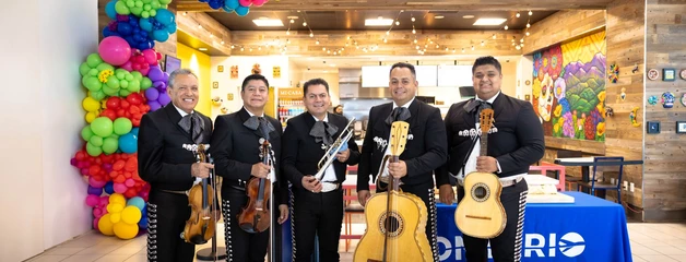 Mariachi players stand in front of Mi Casa Cantina restaurant.