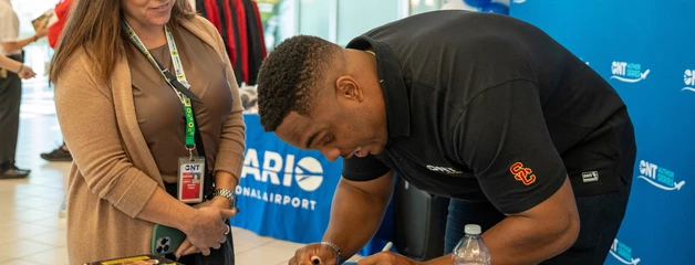 a person waiting for an author to finish signing their book
