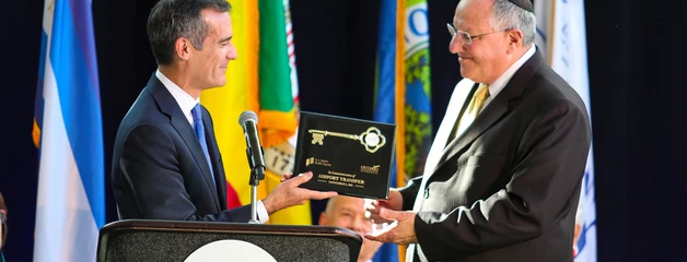 Los Angeles Mayor Eric Garcetti and Ontario Mayor Pro Tem Alan Wapner shake hands and exchange a key to Ontario International Airport.
