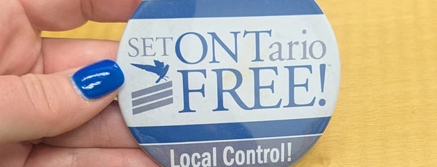 A hand holds a button that says "Set ONTario Free! Local Control!"