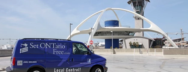 A blue van with the Set ONTario Free logo is parked in front of LAX.