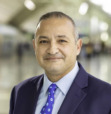 Photo of O N T C E O, Atif Elkadi, smiling in the airport. 