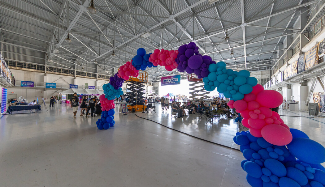 Image of the hangar filled with fans getting ready to watch the game